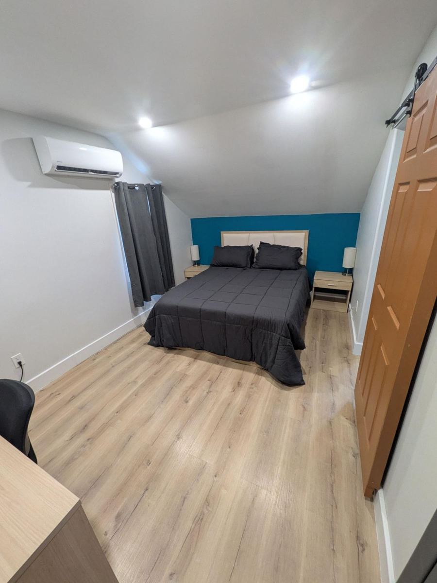Bright room with queen bed and two nightstands