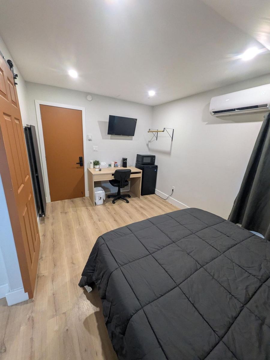 Work desk, mini fridge, microwave and wall-mounted TV