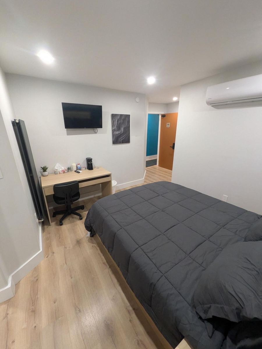 Room with TV, desk and split A/C unit